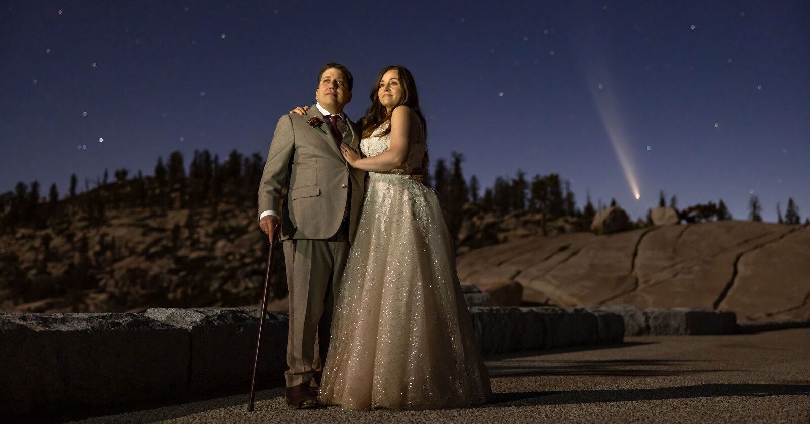 Wedding portraits under night sky with stars and a comet.