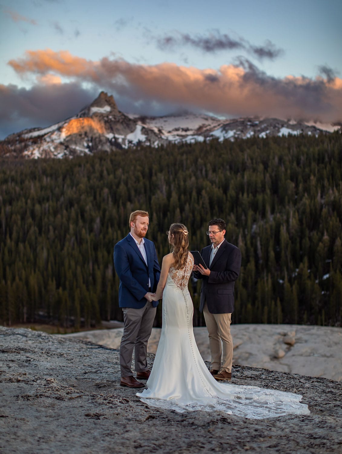 Wedding couple on alpine Sierra dome at sunset.