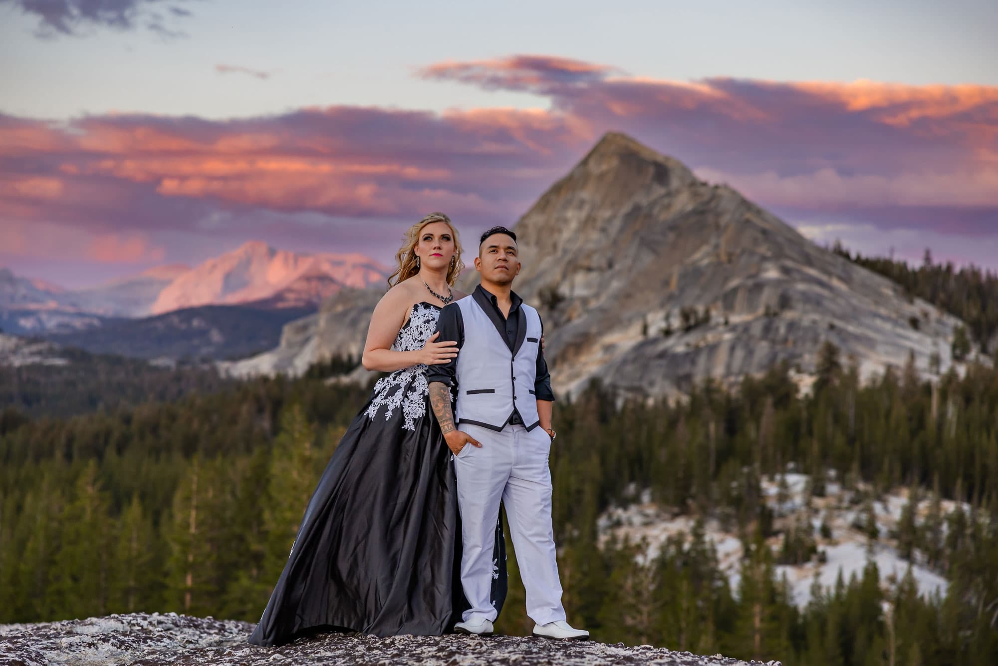 Wedding couple on alpine Sierra dome at sunset.