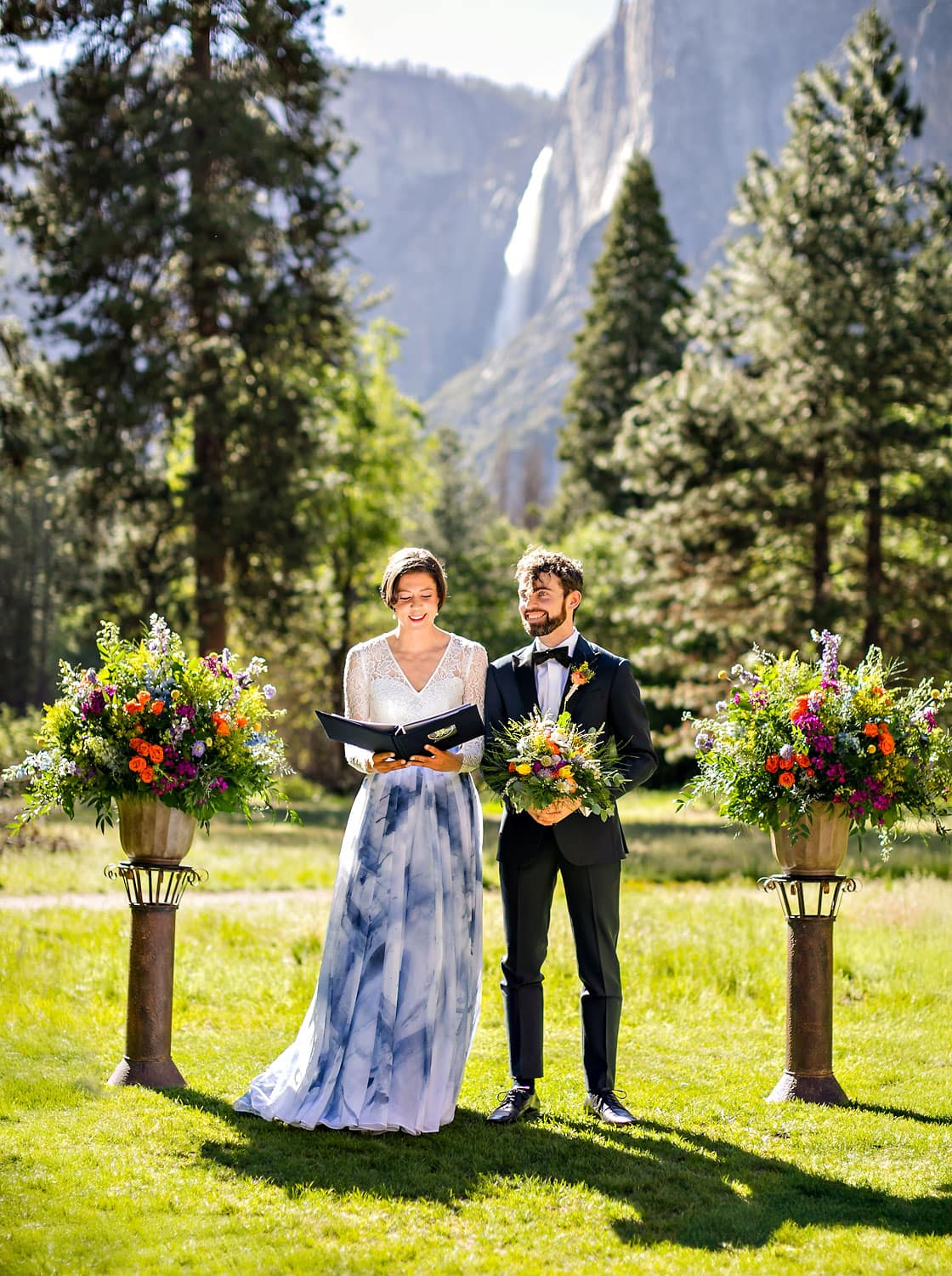 Bride and groom reading a verse during wedding ceremony outdoors.