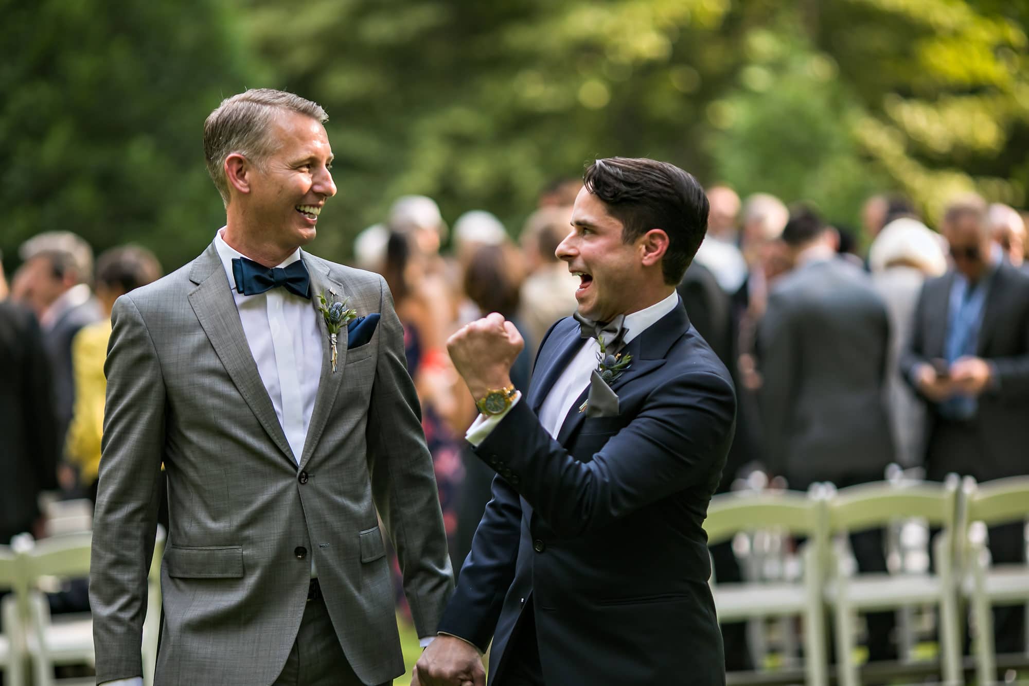 Gay wedding couple rejoicing after ceremony.